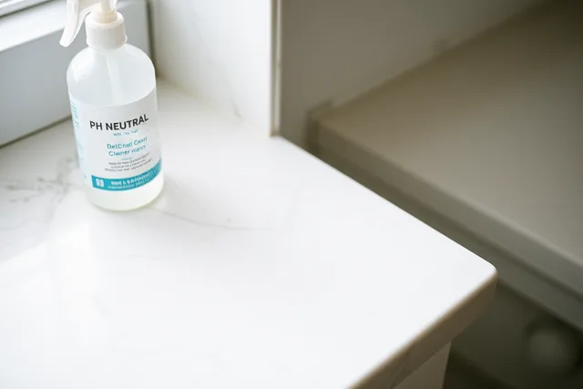 Neutral cleaner mist sprayed on a marble countertop surface. Material selection mistakes: hiding in the cleaning supplies you buy