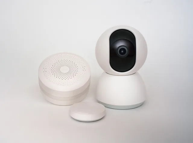 Modern minimalist smart home devices including security camera and sensors in white. Sustainable home projects products worth testing: a reviewer's notes